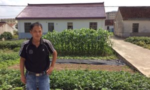 Wu Jianefei and the village home that he built with a lifetime of earnings as a migrant worker