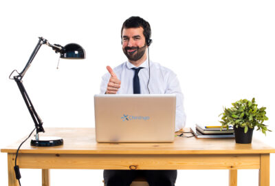 Young man working with a headset with thumb up